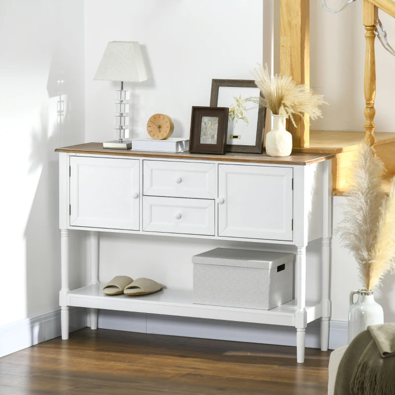 Console avec tiroirs à motifs et pieds en épingle, mise en scène sous une décoration murale florale.