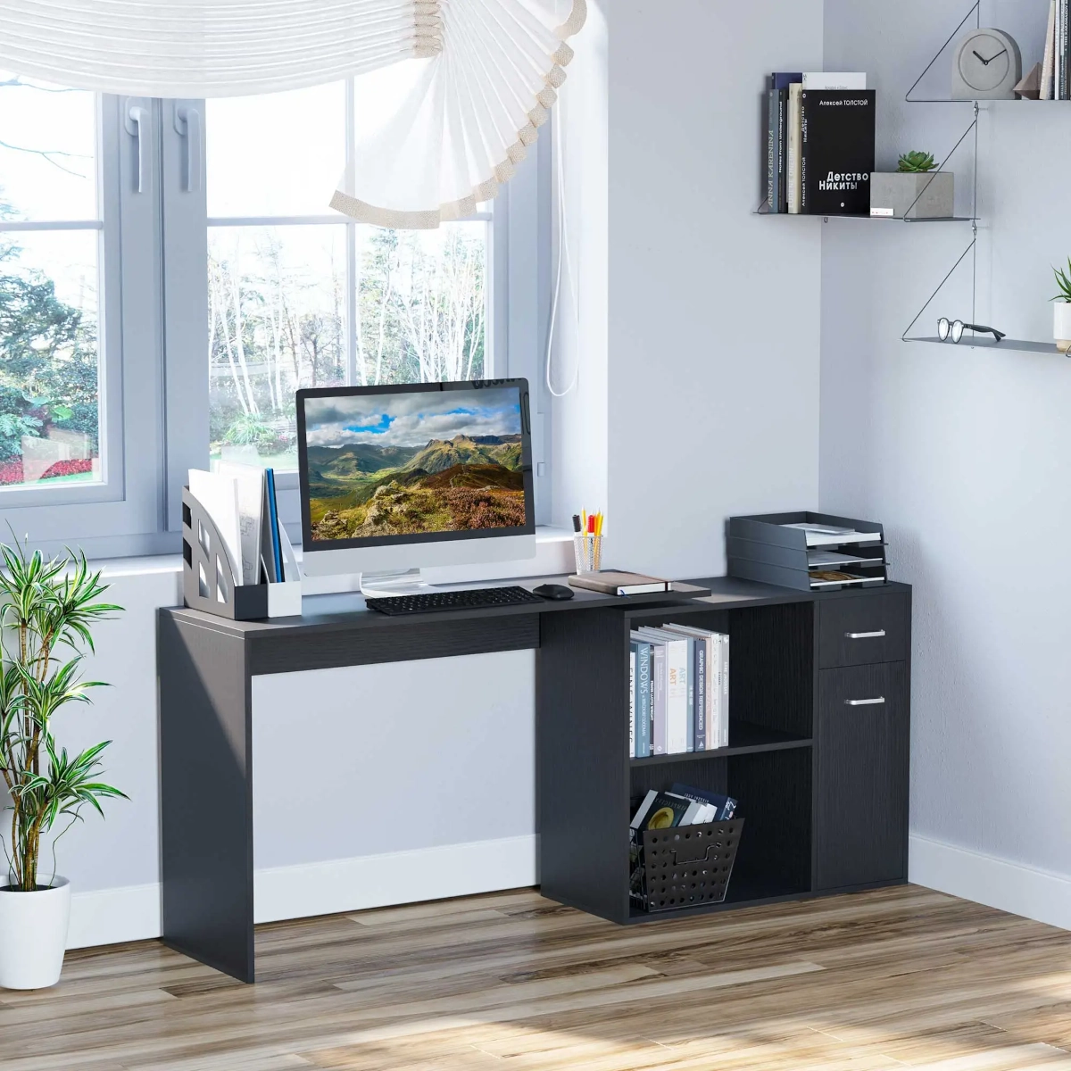 Black desk with drawers, bookshelf, and large monitor.