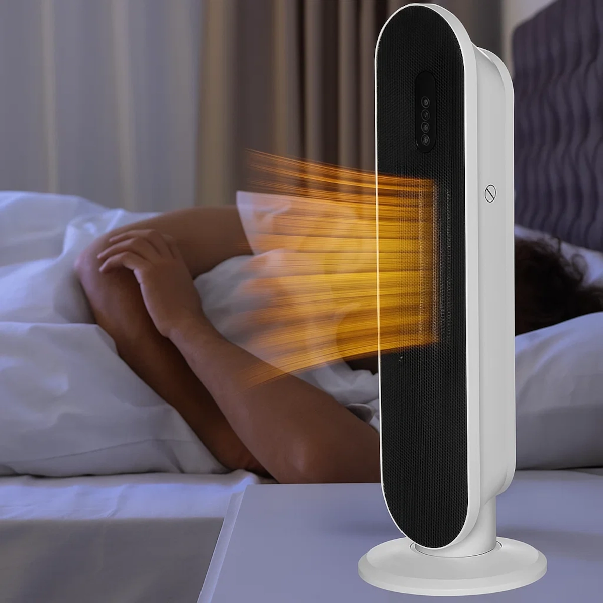Radiateur tour en céramique diffusant un flux d'air chaud à côté d'une personne se reposant au lit.