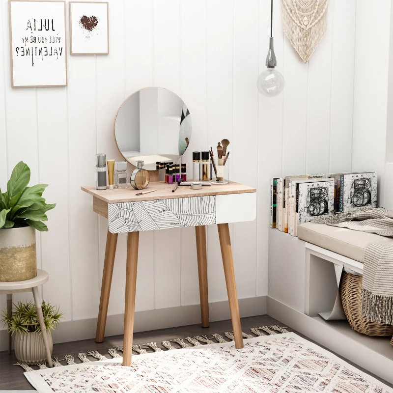 Petite coiffeuse avec un miroir rond, des produits de maquillage et une chaise moderne dans un coin cosy et décoré de blanc.